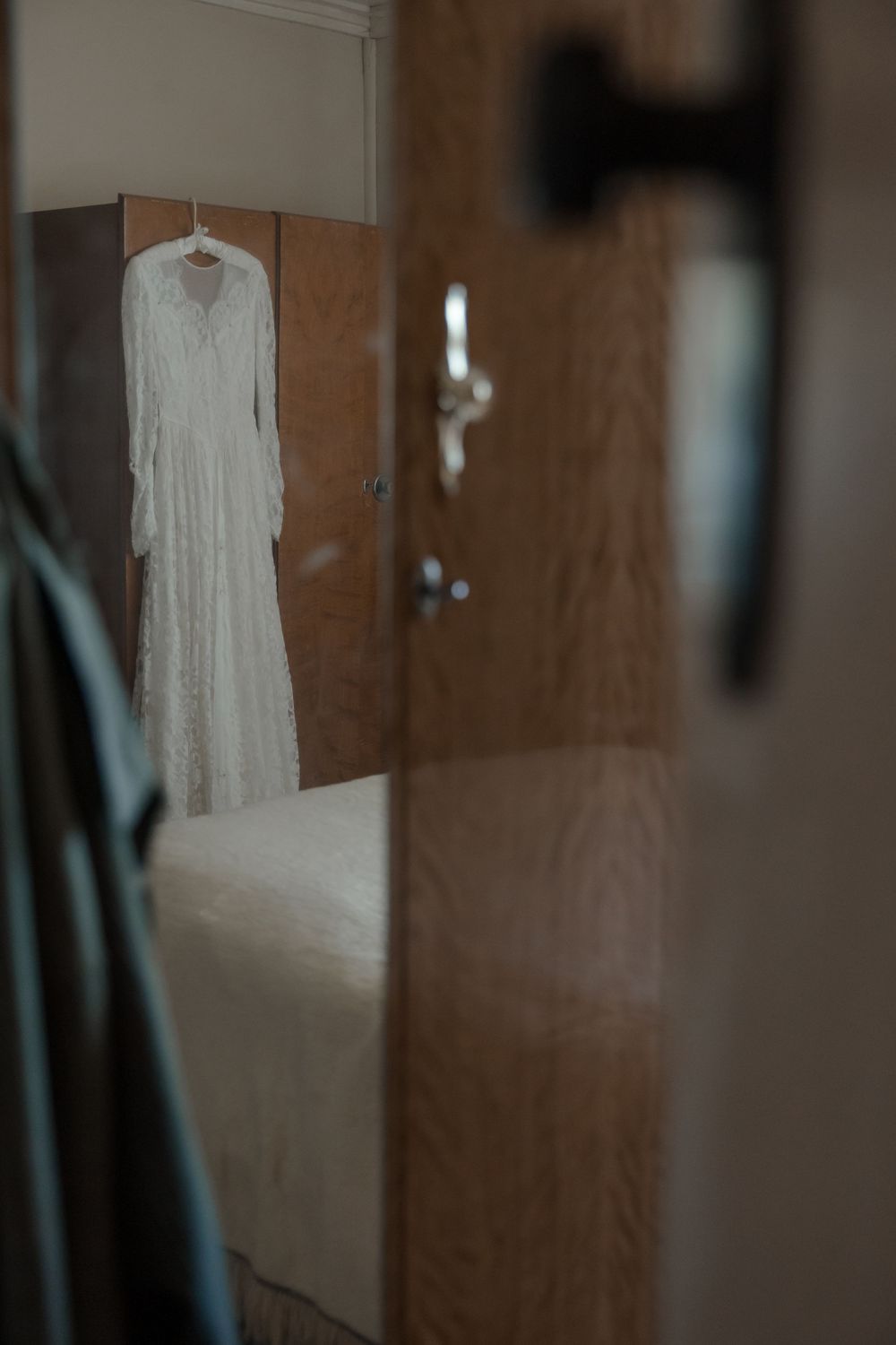 Bride’s wedding dress displayed on a vintage wardrobe in a rural NSW home before an intimate country wedding