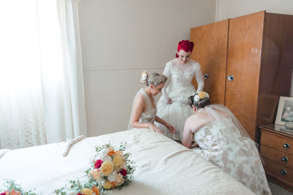 Bride putting on her vintage wedding gown the morning of her Vintage Inspired Country wedding in South Coast NSW on private family land