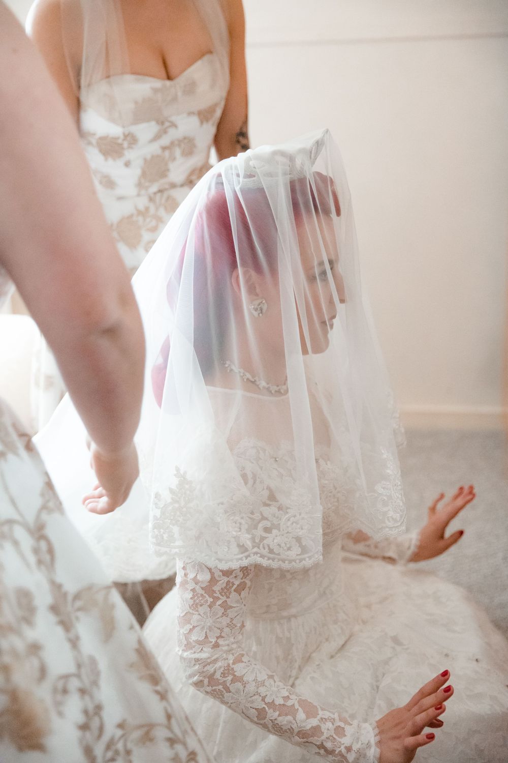 Getting Ready Shot Ideas of the Bride in front of a vintage vanity wearing her Grandmother's Wedding Dress putting on her veil