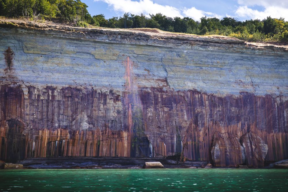 Scenic panoramic view of colorful sandstone cliffs along Lake Superior's shoreline at Pictured Rocks National Lakeshore.