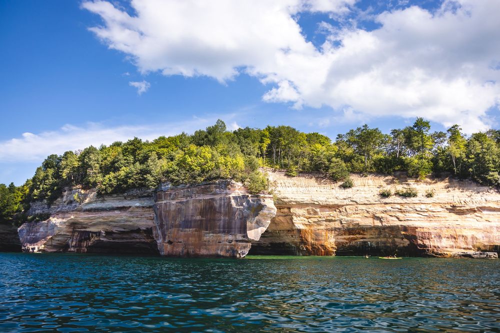 Panoramic view of Lake Superior's Pictured Rocks National Lakeshore showing colorful sandstone cliffs and blue waters.