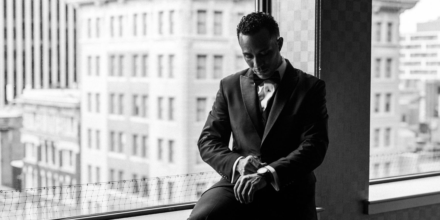 Dramatic black and white portraits in front of city windows.