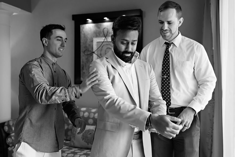Three men in business attire stand together in a black and white photograph from what appears to be the 1950s or 1960s.