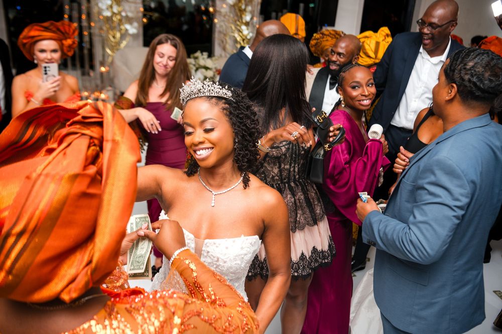Wedding celebration with guests dancing and enjoying festivities in formal attire.