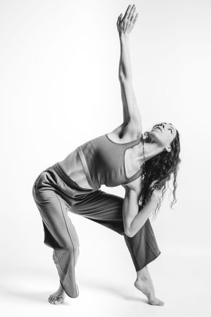 A series of black and white photos showing a dancer performing fluid movements in loose-fitting clothing.