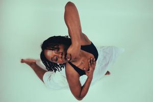 A series of black and white abstract dance movement photographs showing graceful body positions and flowing motion.