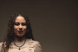 A series of six black and white portrait photographs showing different poses and expressions against a dark background.