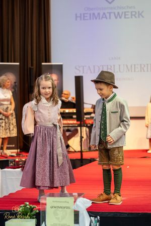 Traditional folk costume presentation with children modeling Austrian heritage clothing.
