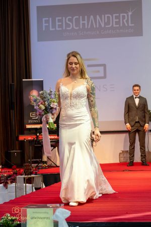 Wedding gowns ranging from fitted to full silhouettes showcased at a bridal fashion event.