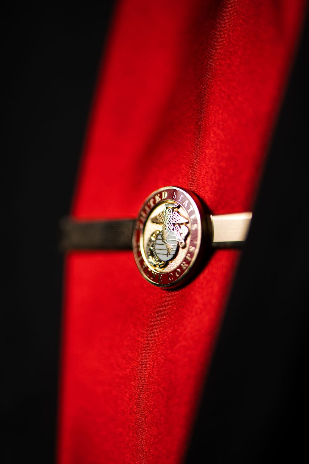 Close-up shot of a gold ring against a vibrant red background.