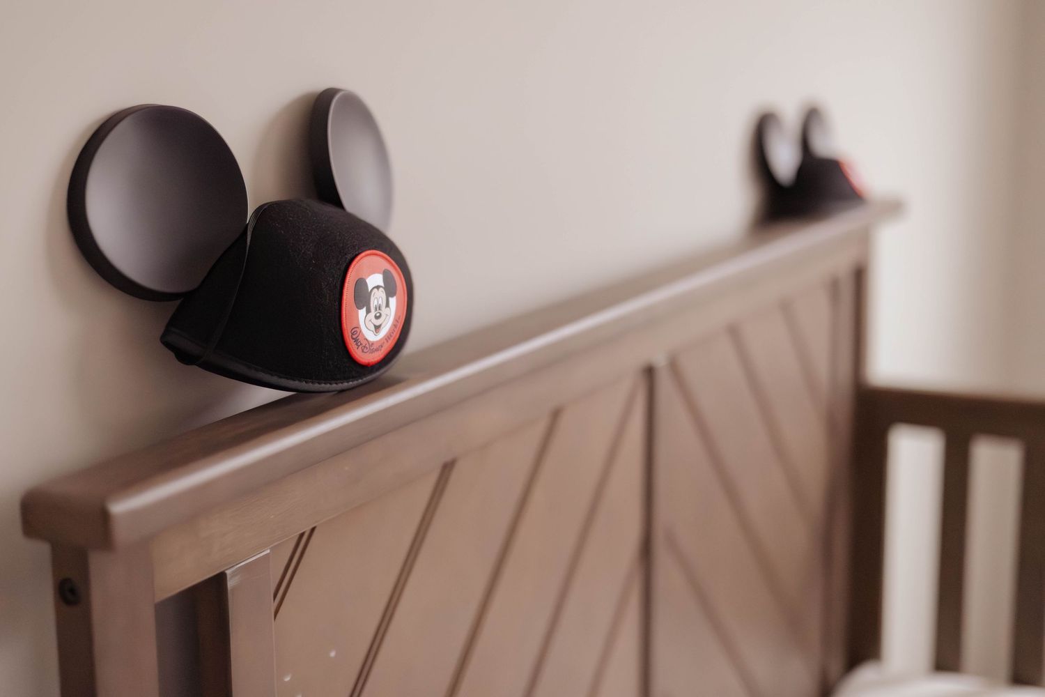 Nursery crib decorated with Mickey Mouse ears for a maternity shoot in Northern Virginia – newborn and maternity photography.