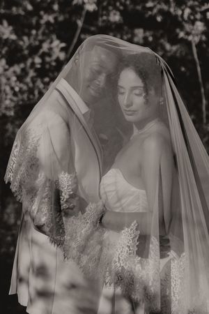 Black and white series capturing intimate bridal moments through a delicate lace veil.