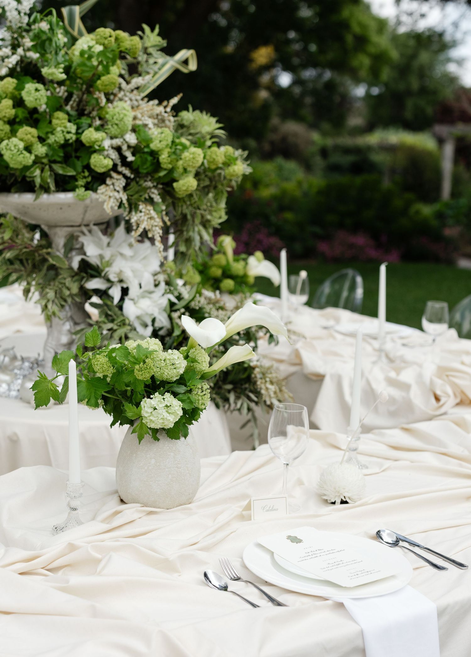 White bar setup with greenery decorations and glassware at an outdoor garden wedding reception at Al Ru Farm in Adelaide taken by Mia