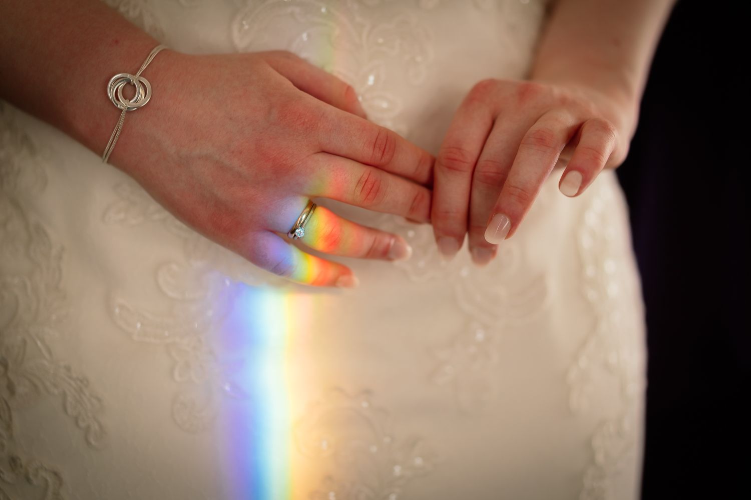 Rainbow light prism effect captured on white lace fabric creating a magical moment. Ellingham Hall