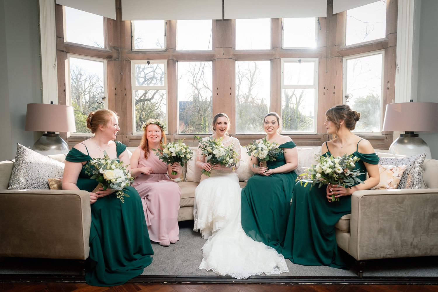 Elegant wedding venue with large bay windows and natural light streaming in. Ellingham Hall