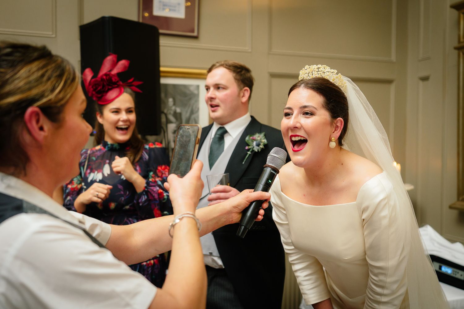 Elegant indoor wedding celebration with guests gathered in a traditional venue. Ellingham Hall