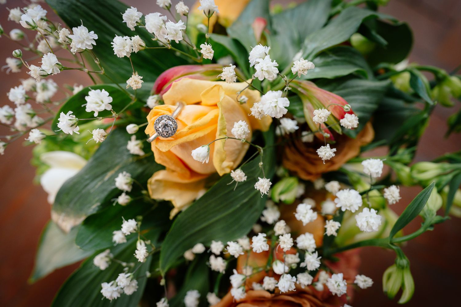 Wedding bouquet with peach roses and delicate white baby's breath flowers.
