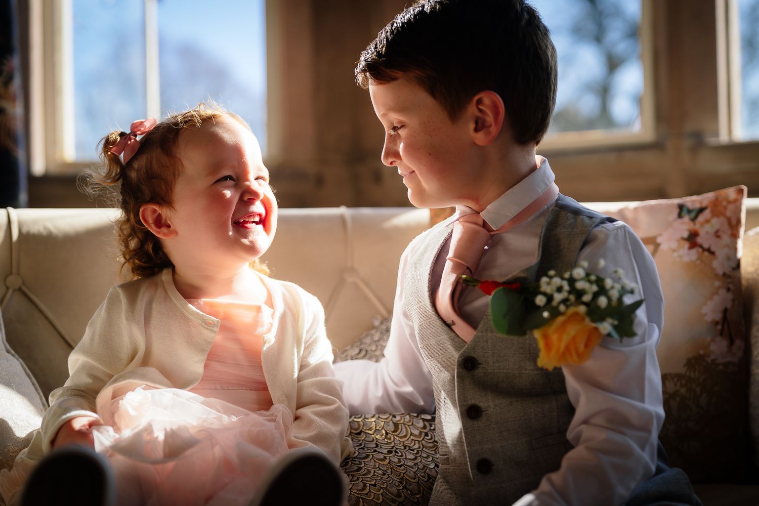 Candid moments captured in natural window light during wedding preparations.