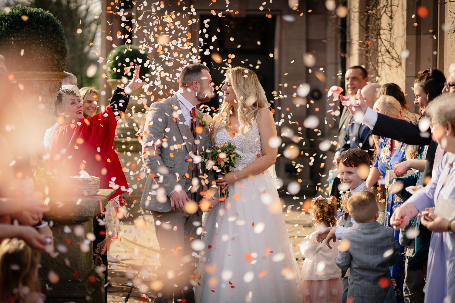 Wedding guests celebrate with sparklers creating magical light trails in the evening.
