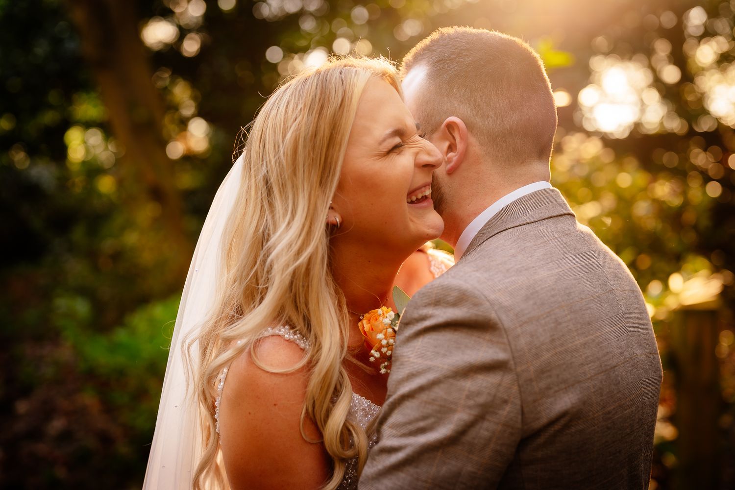 Romantic golden hour portrait of newlyweds in warm sunset light.