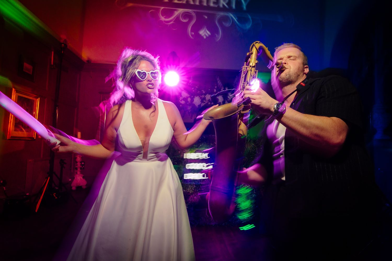 Wedding celebration with dynamic lighting and dancing captured in a series of action shots.
