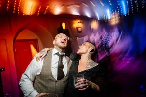 Wedding reception dance floor illuminated with dramatic red and blue lighting effects. Ellingham Hall