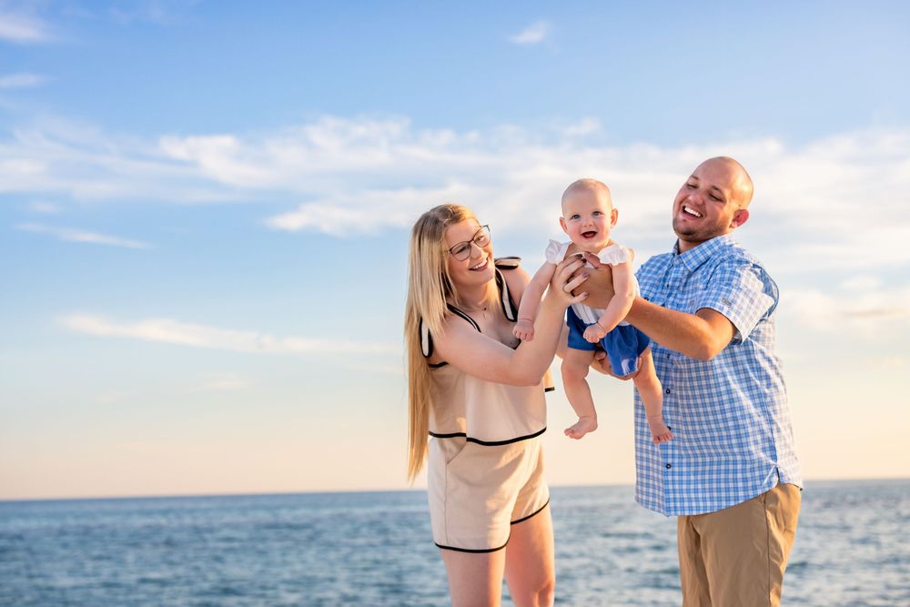 Family enjoying a playful day at the beach with sunset ocean views.