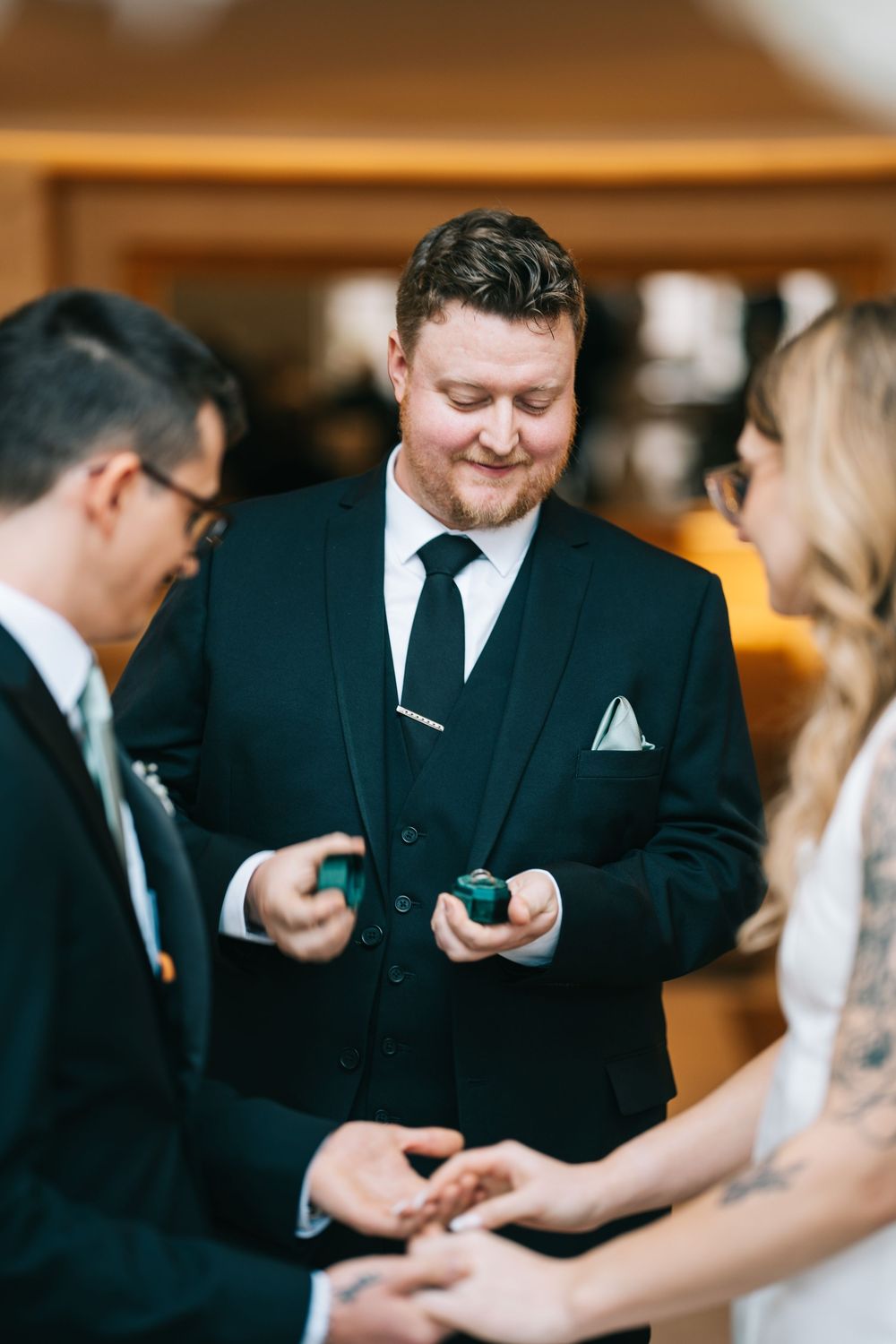 Wedding ceremony moments showing rings being exchanged between the couple.