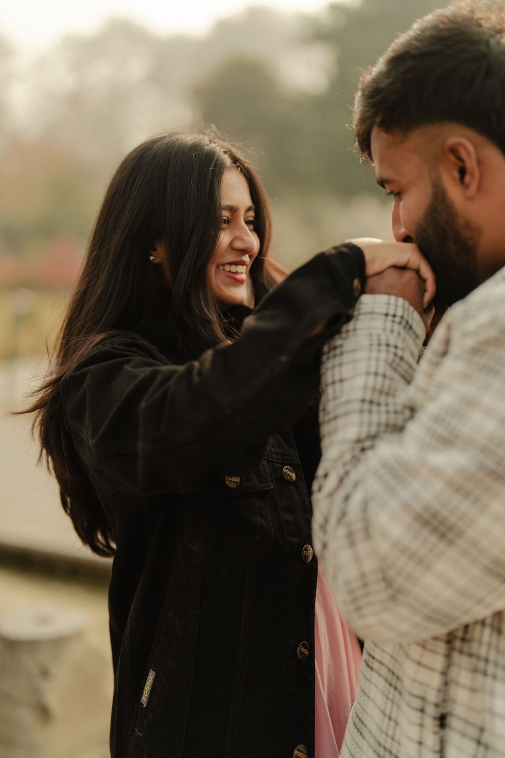 A romantic couple shares intimate moments in a series of candid outdoor photos with soft lighting and natural scenery.
