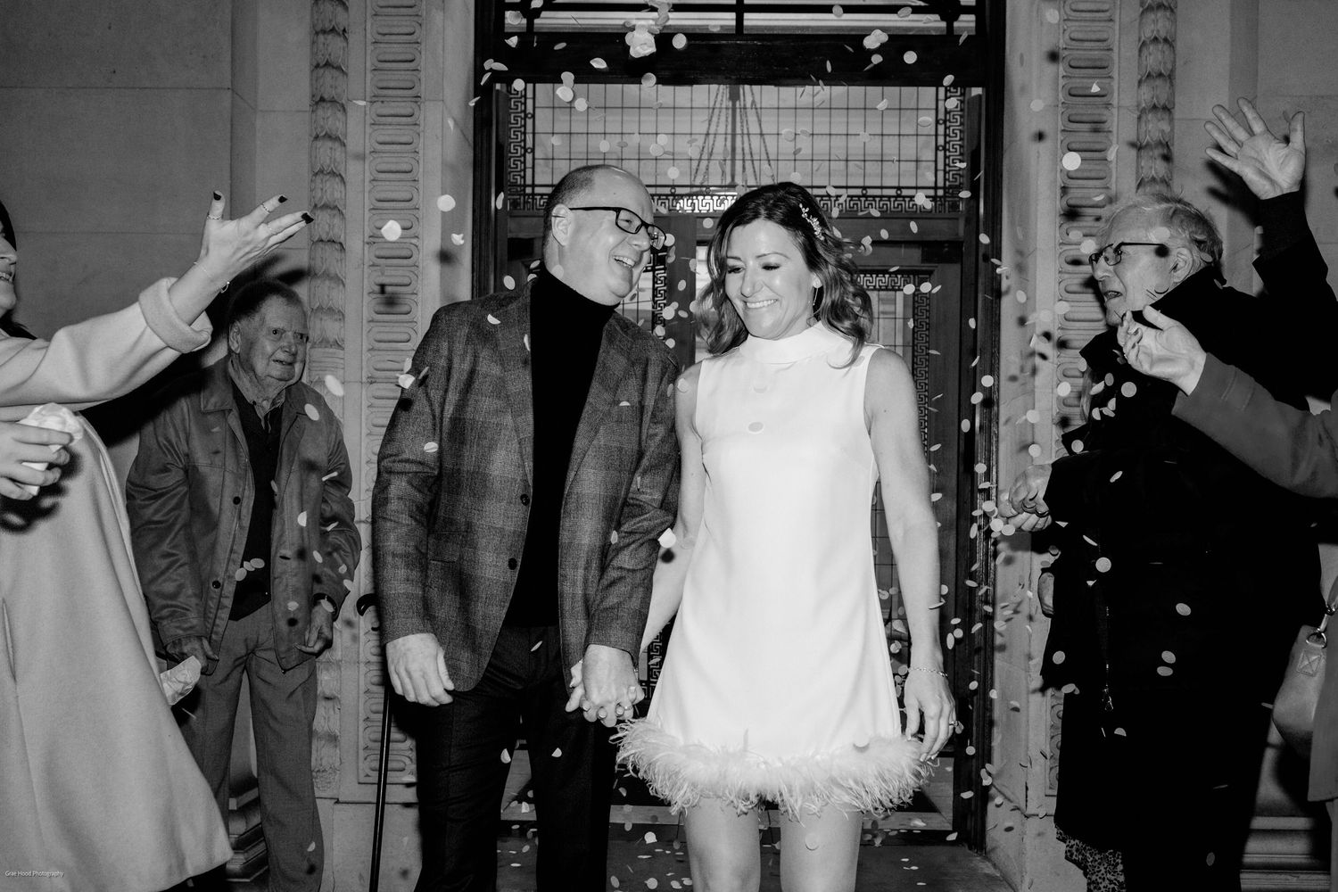 Wedding guests dance and celebrate during a lively reception party in a decorated indoor venue.
