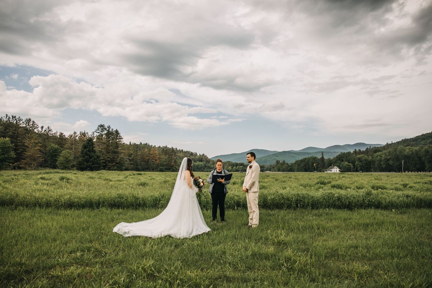 couple eloping in marcy field with mountains and field in the adirondacks