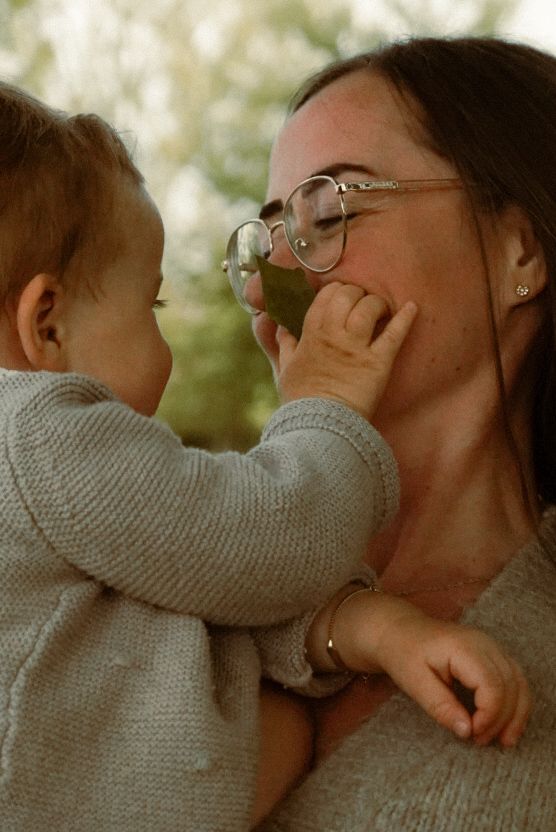 Tender moments between a child and adult in cozy grey sweaters.