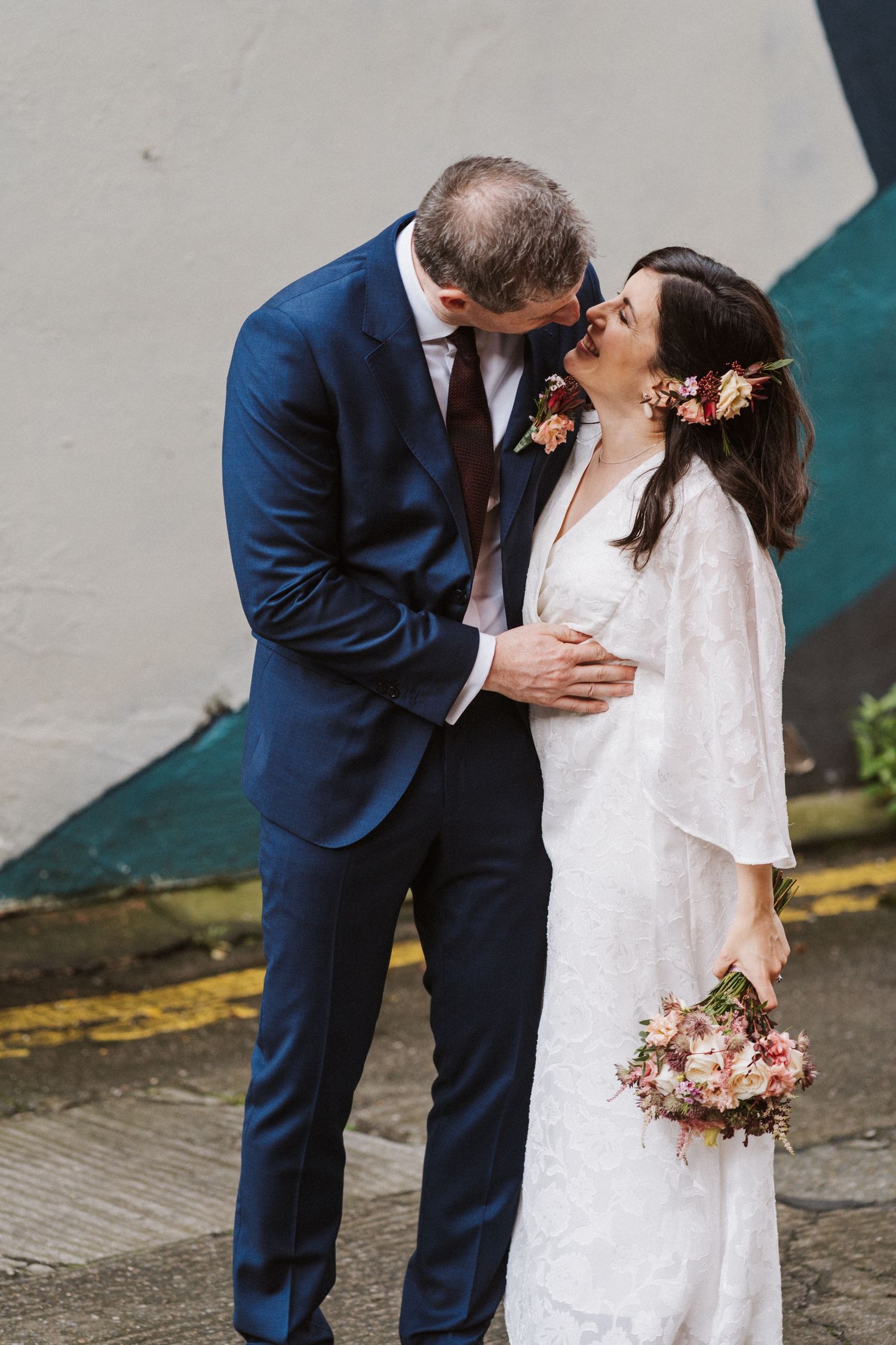 A romantic sequence of wedding photos showing a couple in navy suit and white dress sharing tender kisses.