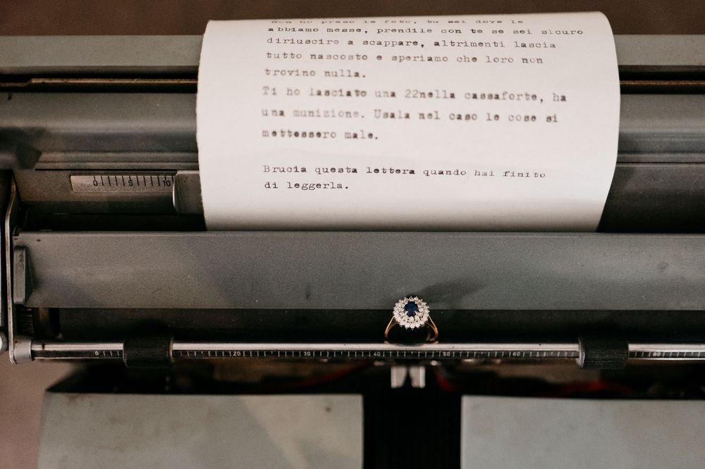 A vintage typewriter with a sheet of paper containing typed text.