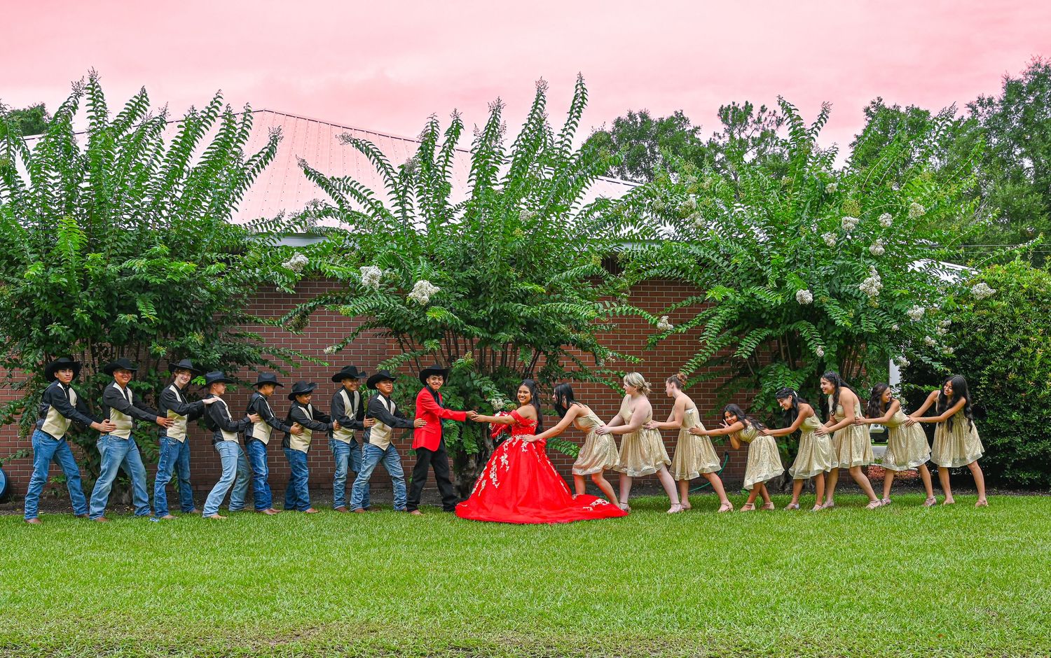 A stunning red ballgown photoshoot in a serene forest setting showcases elegant poses and flowing fabric against natural scenery.