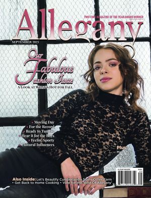 A magazine cover for Allegany featuring a model in black lace against a window backdrop.