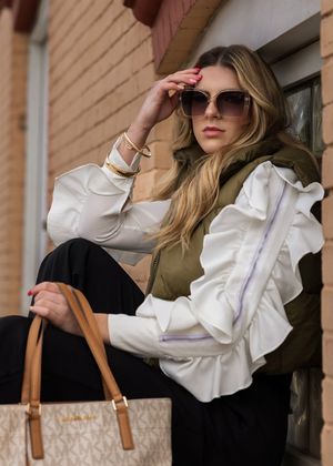 A designer handbag with tan leather straps and white monogram pattern shown from multiple angles.