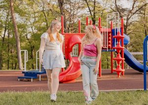 A series of playground photos showing legs and feet of people walking on grass and playground surfaces.