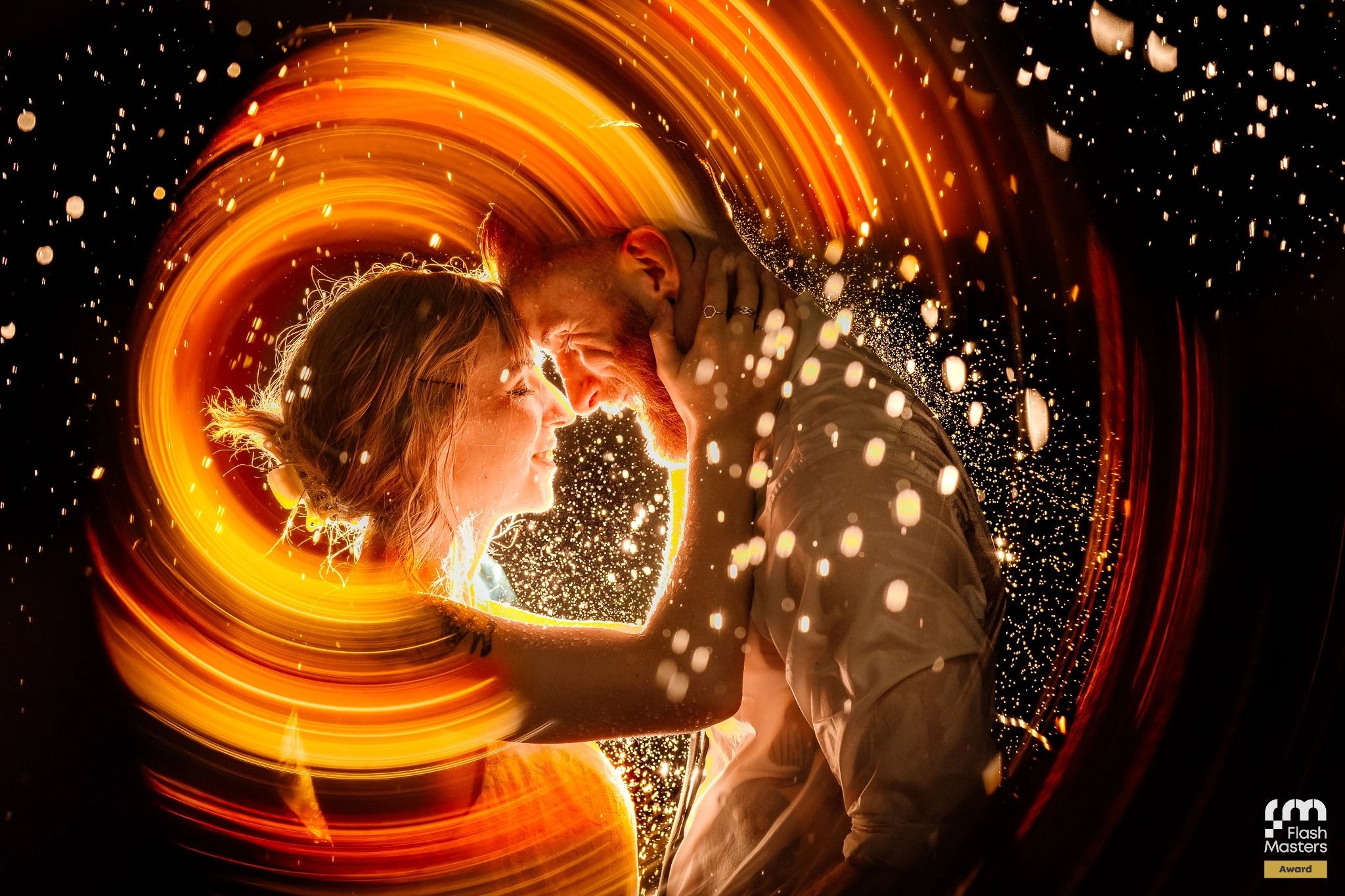 Abstract spiral light trails with bokeh effects against dark background creating magical patterns.