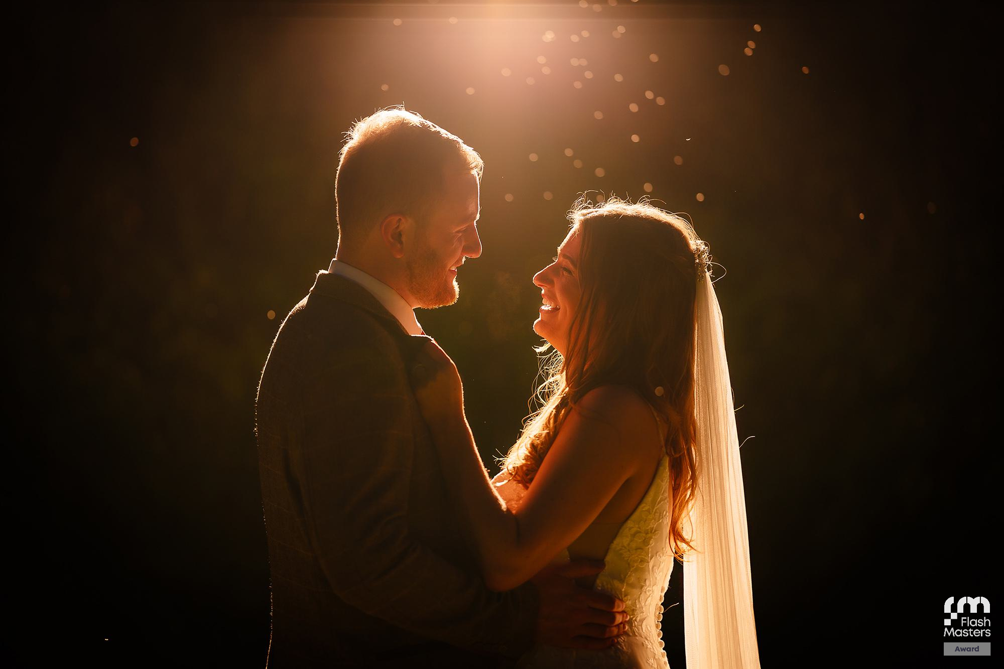 Romantic backlit silhouettes with warm golden rim lighting creating an intimate atmosphere.