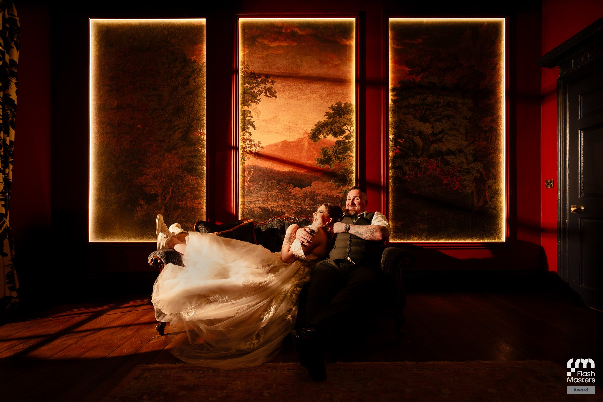 Artistic wedding venue lighting with illuminated frames creating a dramatic red ambiance.