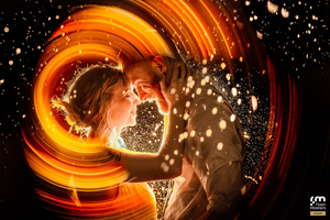 Abstract spiral light trails with sparkles creating a magical golden vortex effect.