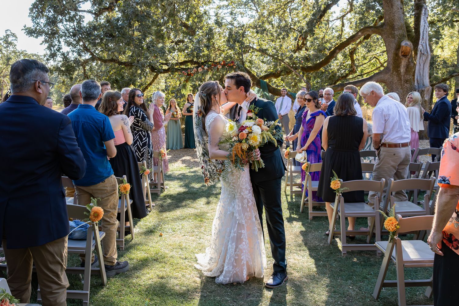 Bride and groom share a romantic kiss during an outdoor garden wedding at Mt.Pisgah Arboretum.