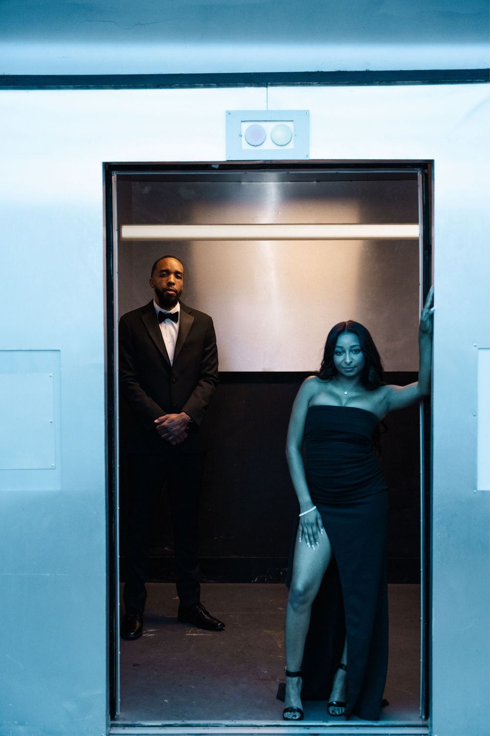 Artistic series of elevator photos showing figures in formal attire captured in a moody blue-tinted lighting.