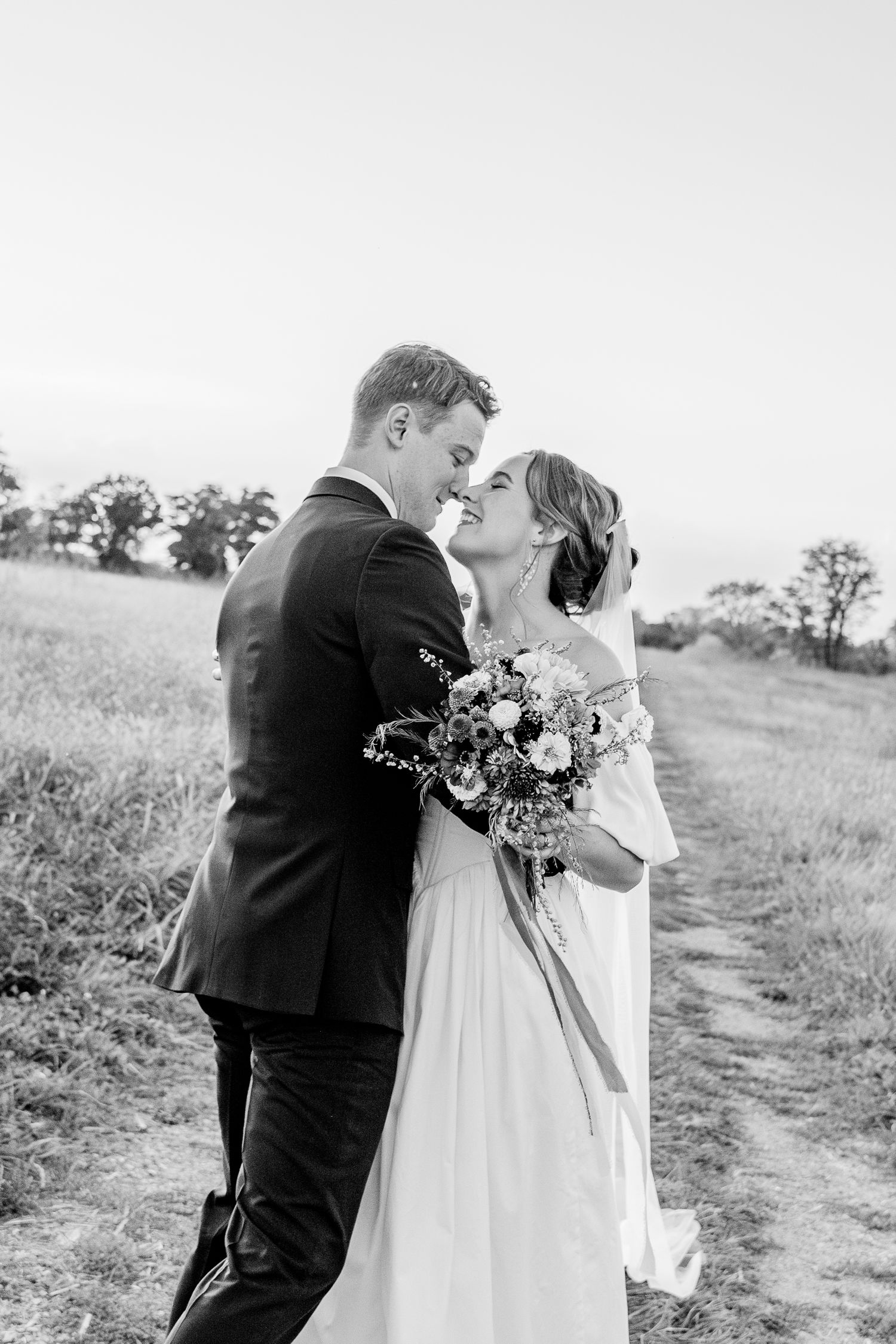 A romantic black and white photo captured on a hillside path.