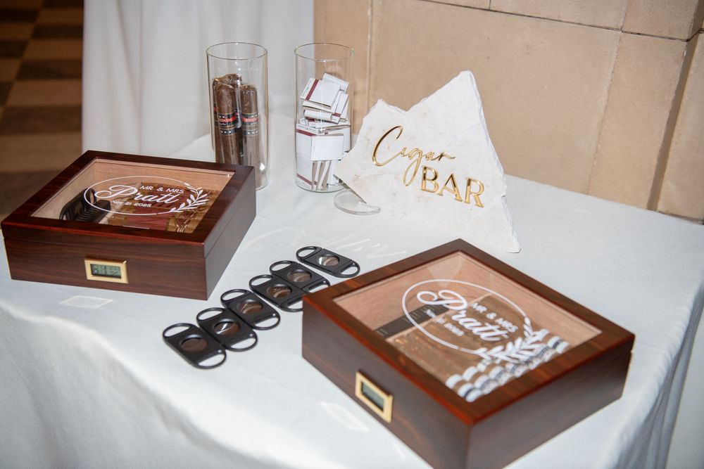 Wedding favor table with custom sunglasses and personalized gift boxes.