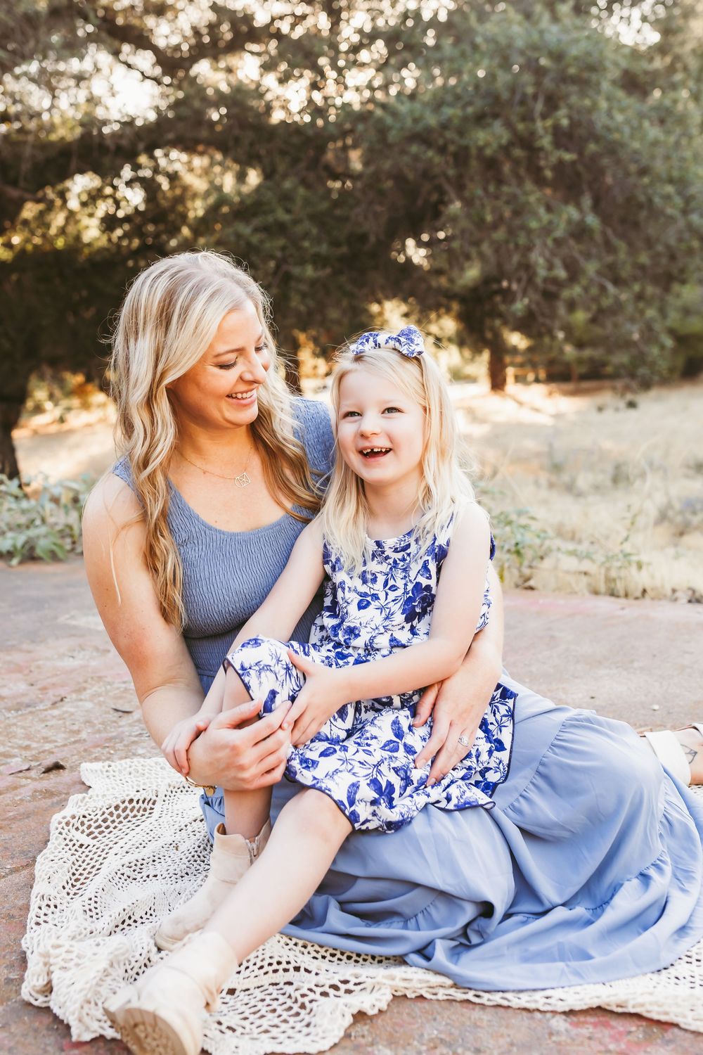 Candid moments of laughter and connection during a sunset portrait session on a blanket outdoors.