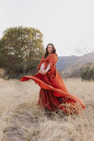 Dramatic red dress movement captured in a series of outdoor poses.
