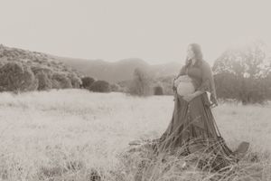 Vintage-style black and white maternity photos in natural outdoor setting.