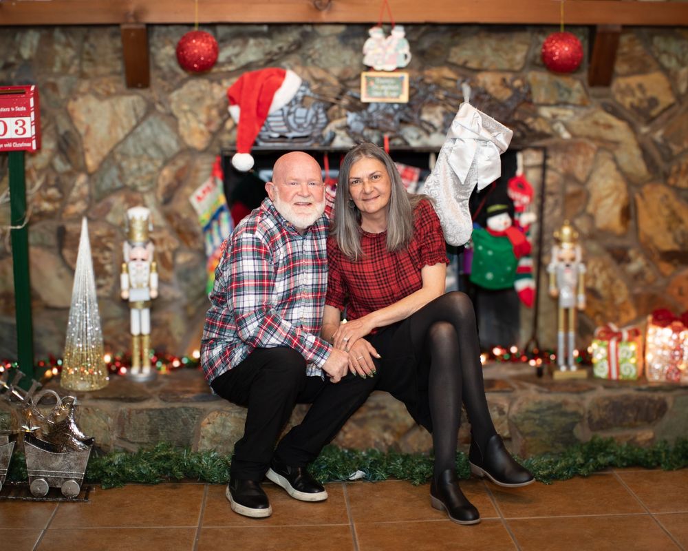 Feet of people wearing casual shoes and plaid shirts sitting together during Christmas holiday season.